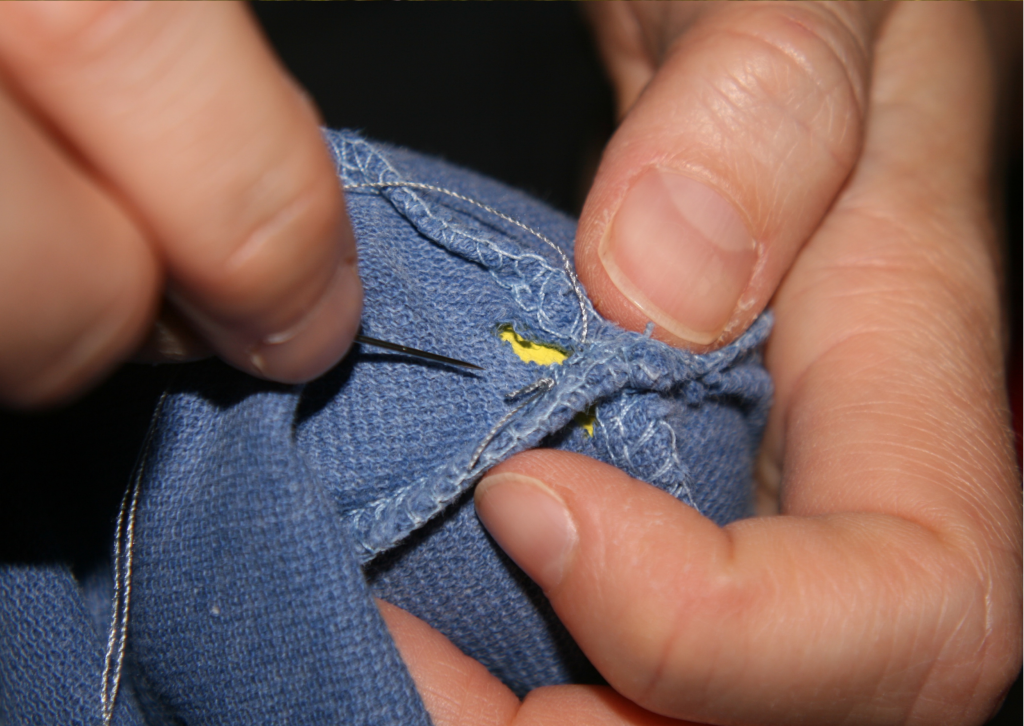 sewing up holes and helping the environment by mending our clothes