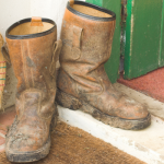 Putting Muddy Boots On Doormat To Keeping The House Clean In Winter